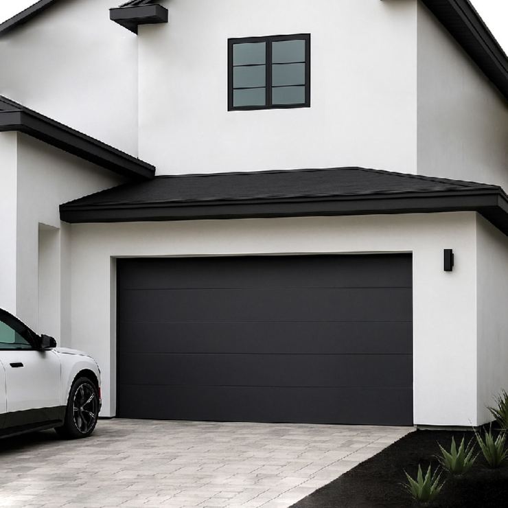 Black flush-panel modern garage door on a white house